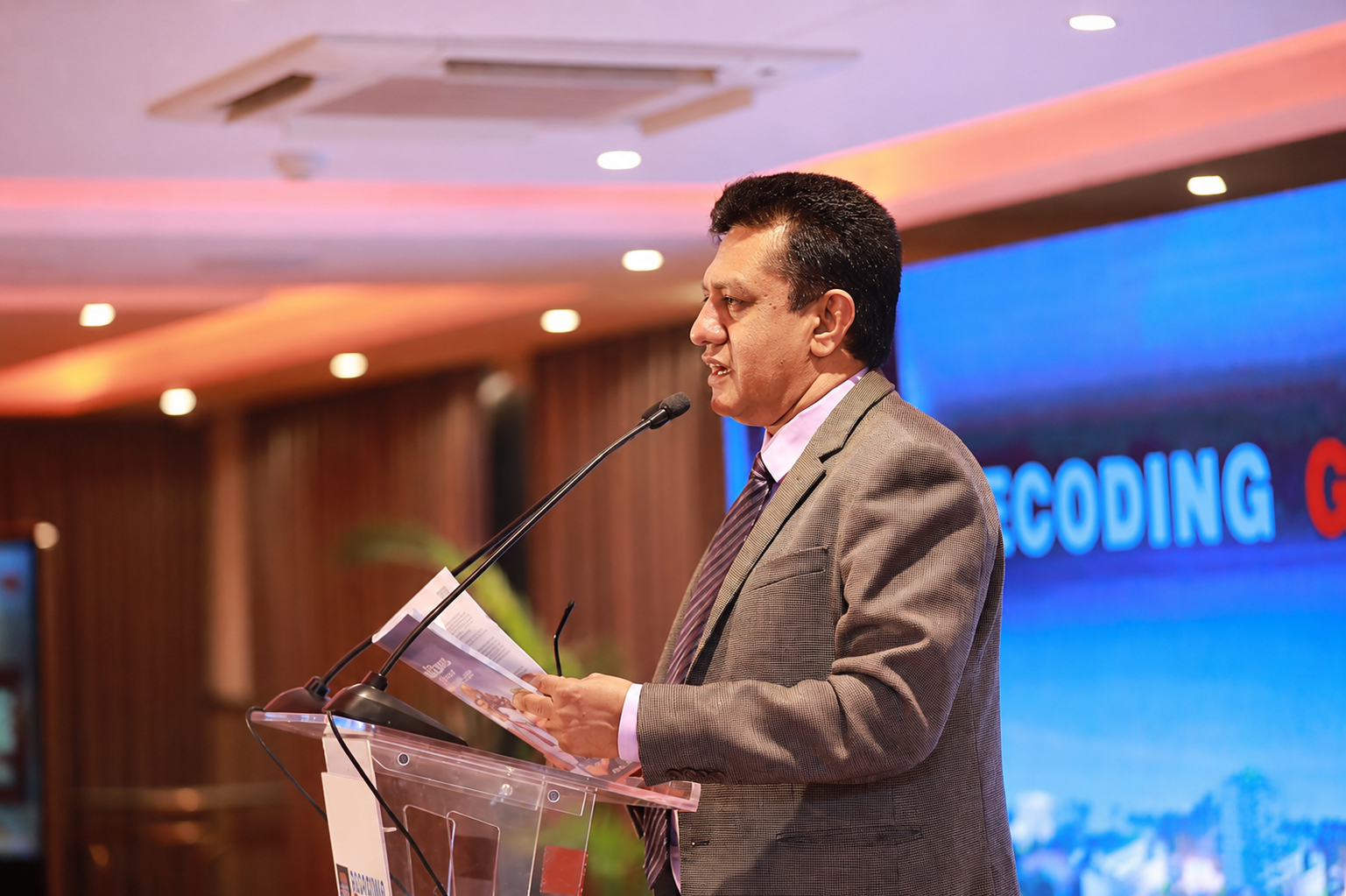 Professor Charitha Herath addressing an audience from a podium